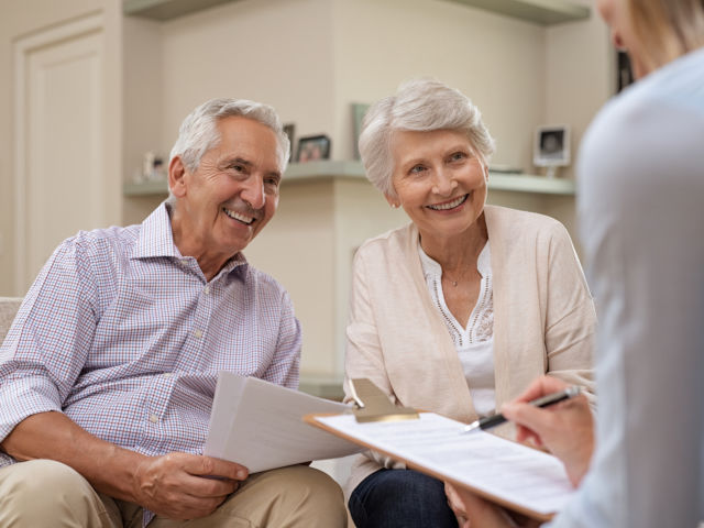 Senior couple meeting real estate agent at home. Old husband and